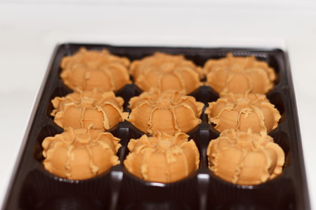 chocolate mochi in a black box on a white background