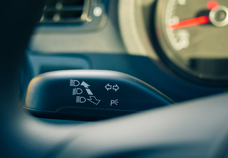 Turn signal seen behind the steering wheel closeup