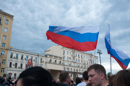 RUSSIA, MOSCOW, 2017 - JUNE 12. Russian tricolor flags waving on a wind under the stormy skies at anti-corruption rally at Tverskaya streetのeditorial素材