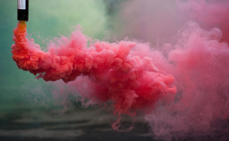 coloroful pink smoke bombs in actionの写真素材