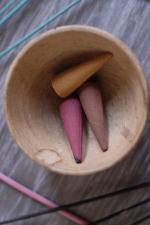 incense sticks and cones, in a wooden bowlの写真素材