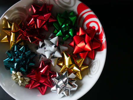 a plate full of christmas multicolored decoration, with black background