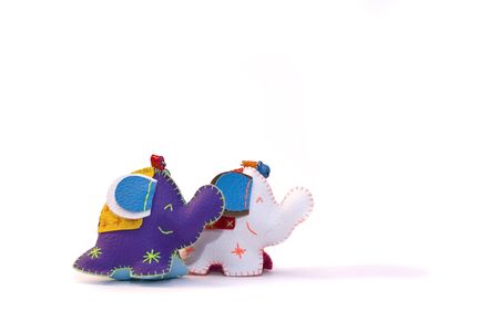 Two smiling toy elephant on a white backgroundの写真素材