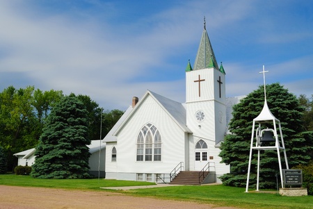 Whitewashed Church Against a Blue Sky in a Rural Midwestern Townの写真素材