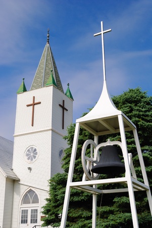 Whitewashed Church and Bell Against a Blue Sky in a Rural Midwestern Townの写真素材