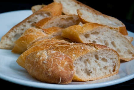 French bread Slices on a White Plateの写真素材