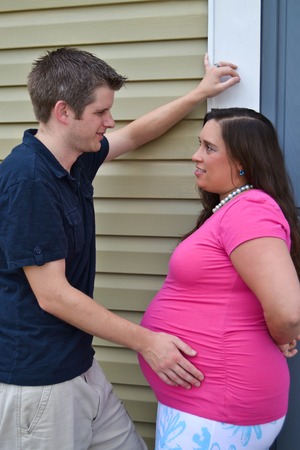 Expectant Couple Standing Against a Wallの写真素材