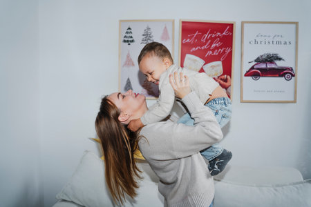 Mother and Son Celebrating Christmas Near a Decorated Treeの写真素材