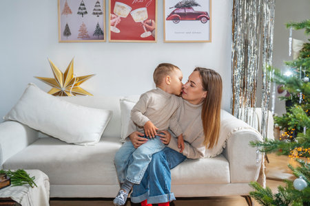 Mother and Son Celebrating Christmas Near a Decorated Treeの写真素材
