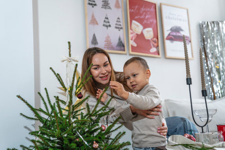 Mother and Son Celebrating Christmas Near a Decorated Treeの写真素材