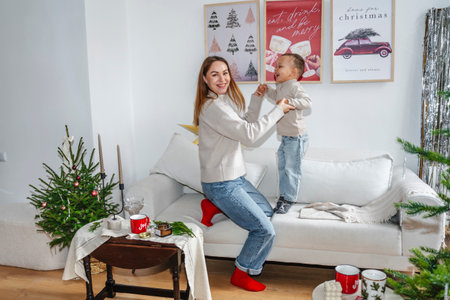 Mother and Son Celebrating Christmas Near a Decorated Treeの写真素材