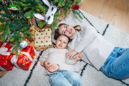 Mother and Son Celebrating Christmas Near a Decorated Treeの写真素材