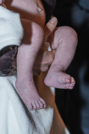 Baby feet being prepared for baptism in an Orthodox church. A symbol of purity and new life.の写真素材