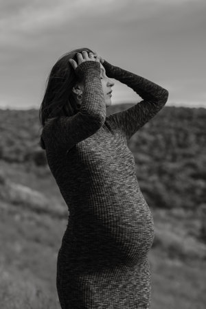 Pregnant Woman in Nature in Autumn, Tender Moment of Expectationの写真素材