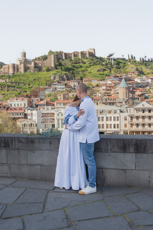 Engagement proposal in Tbilisi: Groom proposing to bride in traditional Ukrainian wedding attireの写真素材