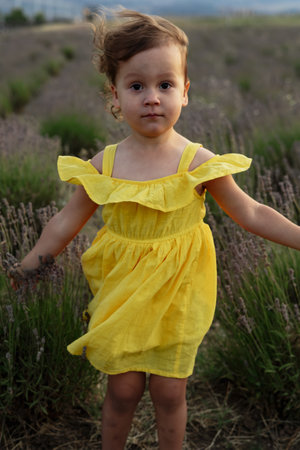 Mother and daughter enjoying a joyful picnic, running in the park, playing by the lake, and having fun in a lavender field. Bright outfits, summer vibes, and heartfelt family moments.の写真素材