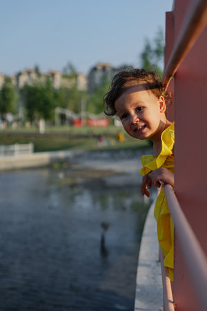 Mother and daughter enjoying a joyful picnic, running in the park, playing by the lake, and having fun. Bright outfits, summer vibes, and heartfelt family moments.の写真素材