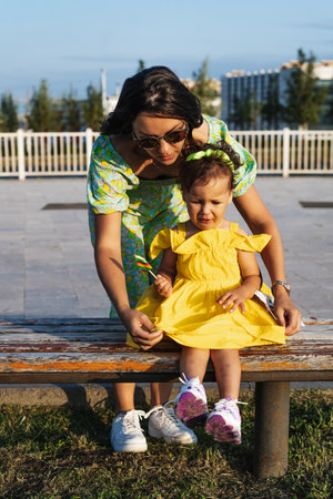 Mother and daughter enjoying a joyful picnic, running in the park, playing by the lake, and having fun in a lavender field. Bright outfits, summer vibes, and heartfelt family moments.の写真素材