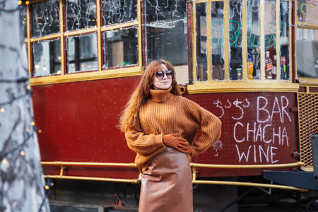 Smiling red-haired woman at a European-style Christmas market during the day, Tbilisi, Georgiaの写真素材