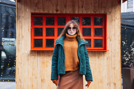 Smiling red-haired woman at a European-style Christmas market during the day, Tbilisi, Georgiaの写真素材