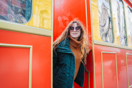 Smiling red-haired woman at a European-style Christmas market during the day, Tbilisi, Georgia