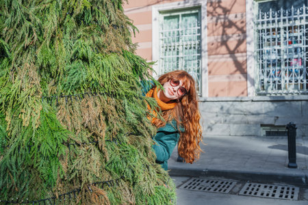 Smiling red-haired woman at a European-style Christmas market during the day, Tbilisi, Georgiaの写真素材