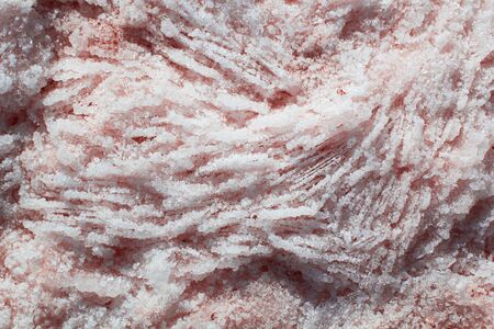 Natural pink salt crystal texture, macro, close up, lamellar structure. Salty lake shore background,...