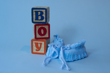 Blue booties and baby bloxks spell out Boy.の写真素材