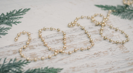 Christmas background with sprigs of arborvitae and gold Christmas beads, which form 2018 on white wooden backgroundの写真素材