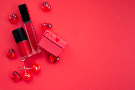 Red flat lay with lipstick and nail polishの写真素材