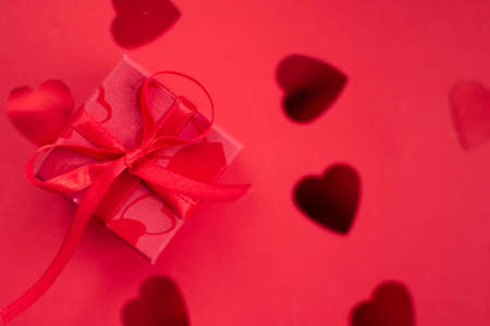 Red gift box on a red background for Valentine's Dayの写真素材