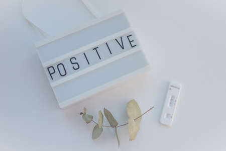Positive pregnancy test on lightboxの写真素材