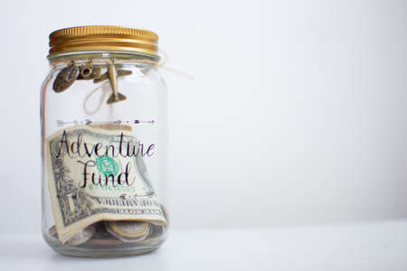 Money in the glass jar on white background. Saving money concept.の写真素材