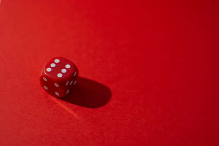 Red dice on a red background with copy space. Casino concept.の写真素材