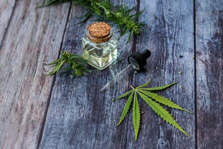 Cannabis herb and leaves for treatment with decoction, tincture, extract, oil. Hemp oil. Selective focus.の写真素材