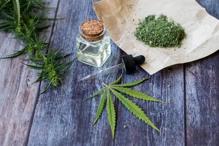 Cannabis herb and leaves for treatment with decoction, tincture, extract, oil. Hemp oil. Selective focus.の写真素材