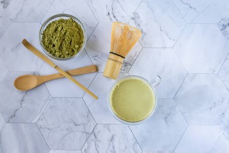 Matcha green tea with froth is a tasty way to enjoy energy and health benefits. Matcha is a green tea leaf powder filled with antioxidants. Horizontal orientationの写真素材