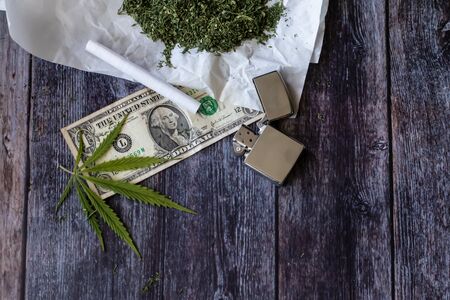 A sheet of marijuana for money, dollars and cannabis, a legal and black market businessの写真素材