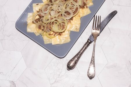 Beshbarmak is a national Kazakh dish - square pasta with boiled meat and onions.の写真素材