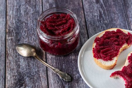 Sandwiches with natural homemade beetroot jam, with vanilla and sugar. Healthy food, vegetarianism. On wooden backgroundの写真素材