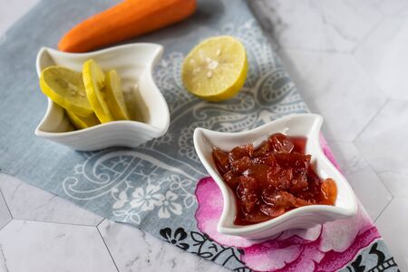 Homemade carrot jam with lemon, sugar and vanilla. In a saucer on a light background. Healthy dessertの写真素材