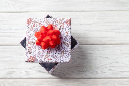 Holiday gift box on a white wooden background. with christmas decorationsの写真素材