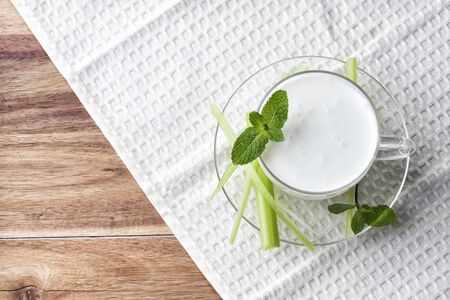 Pouring homemade kefir, yogurt with probiotics. Probiotic cold sour-milk drink. Fashionable food and drinks.の写真素材