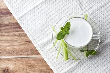 Pouring homemade kefir, yogurt with probiotics. Probiotic cold sour-milk drink. Fashionable food and drinks.