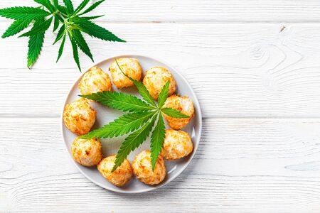 Cannabis and energy balls with marijuana on a white plate, concept of medical marijuana, home cooking. View from aboveの写真素材