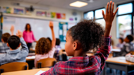 Initiative in the classroom: schoolgirl raising her hand to answerの素材