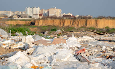 Illegal dumping of garbage in the city's quarry, plastic and other waste. Dangerous pollution in nature. Construction waste.の写真素材