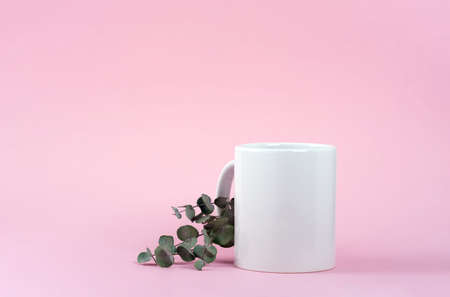 Mockup white coffee cup or mug on a pink background with copy space. Blank template for your design,...