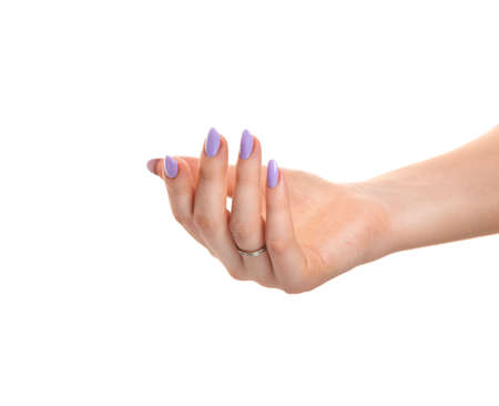 Female hand with purple lavender gel polish on long nails on a white isolated background. Beauty spa concept, manicureの写真素材