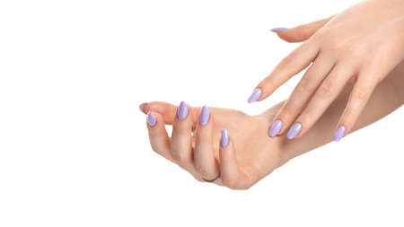 Female two hands with purple lavender gel polish on long nails on a white isolated background. Beauty spa concept, manicureの写真素材